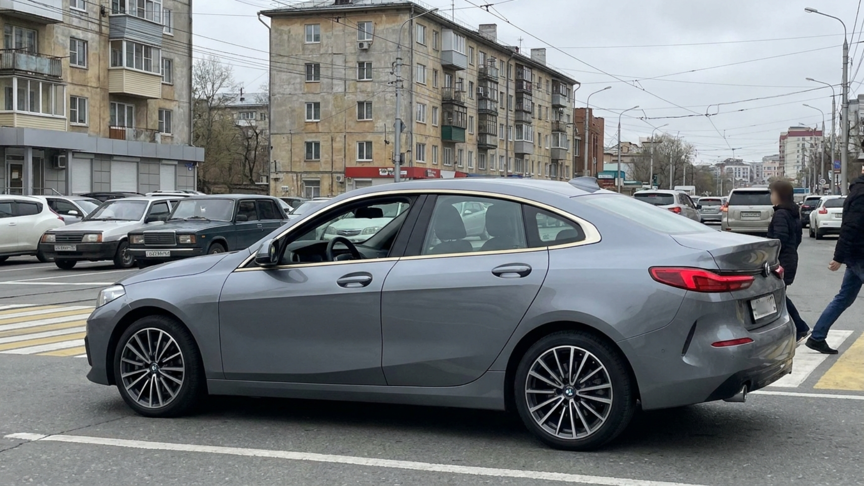 Китайский седан BMW 1-series с левым рулём на городской улице Владивостока