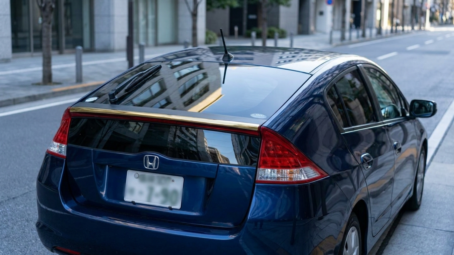 Honda Insight сзади в три четверти, характерное разделённое заднее стекло второго поколения